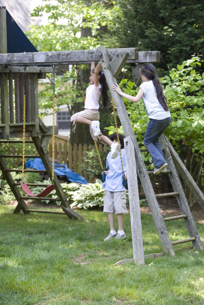 Children love playing outside, and these children were thoroughly enjoying their wooden swing set, having fun in the fresh outdoor air, and the beautiful weather…