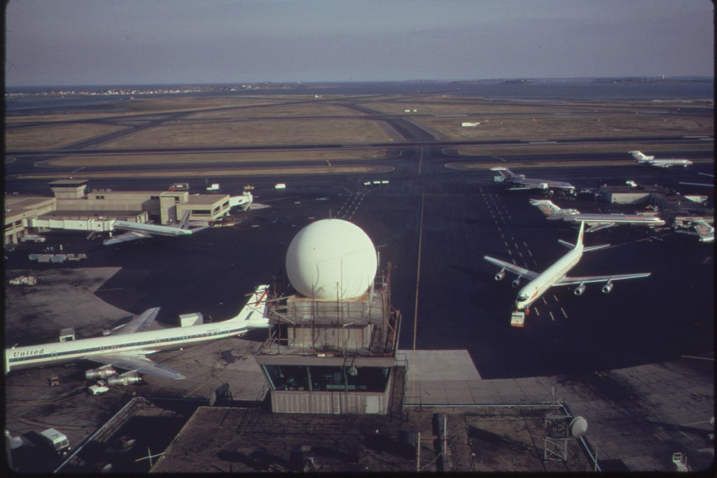 11 of 26 (USA on the Move) - Logan Airport (Boston, MA) - Control Tower and Runways Seen from 16th Floor Observation Deck 09/1973. Photographer: Manheim, Michael Philip. The U.S. National Archives.